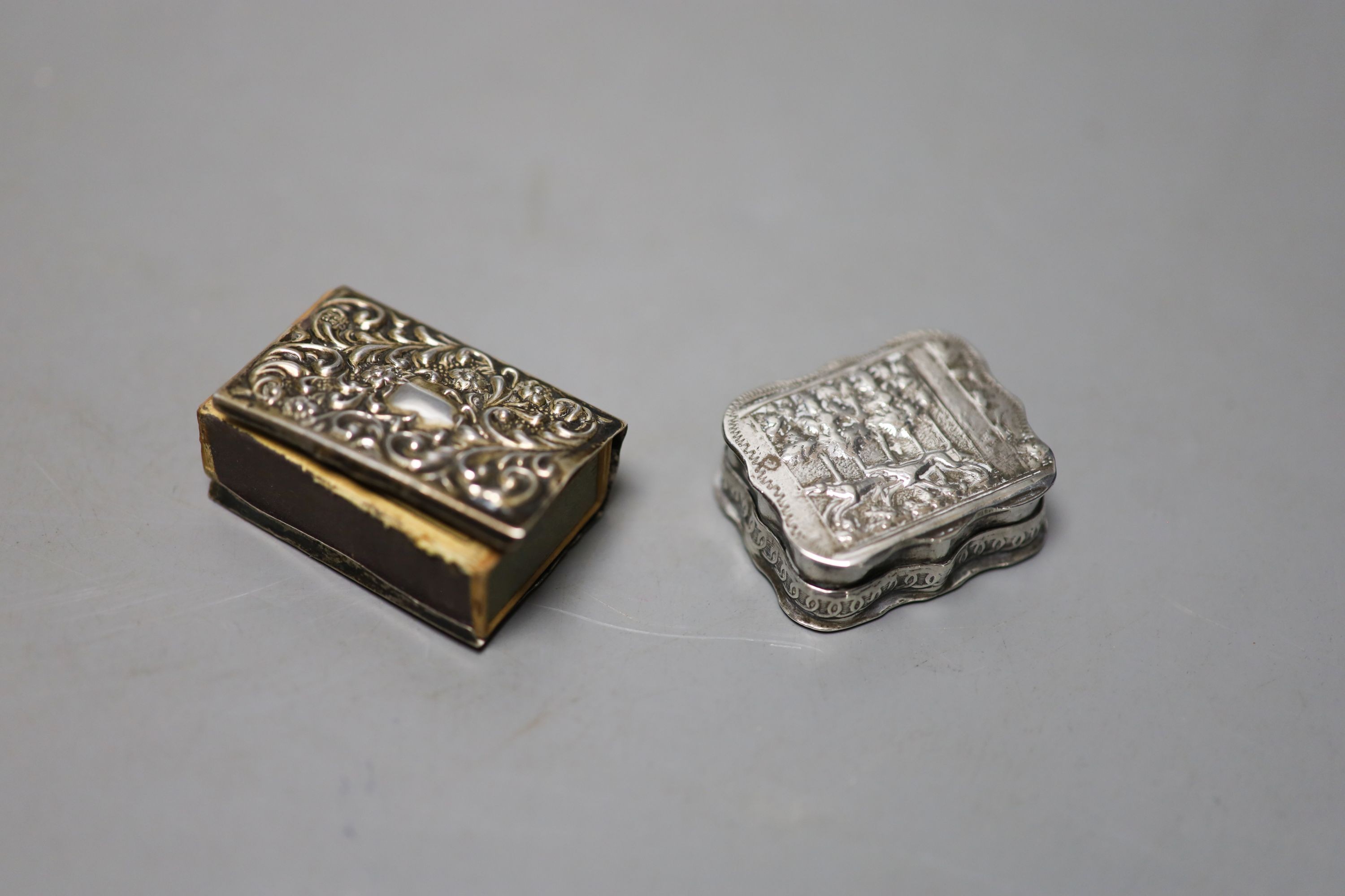 A late 19th century German embossed 800 standard white metal rectangular box, 12.2cm, three smaller boxes, including two silver and a match sleeve.